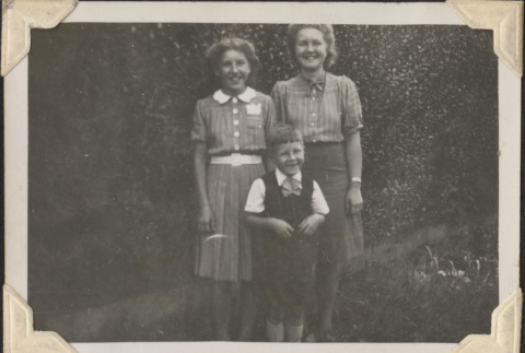 Two women and small boy standing in garden (ddr-densho-466-886)