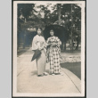 Two women in kimonos with umbrellas (ddr-densho-442-20)