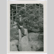 Man sitting on tall rock (ddr-densho-377-1639)