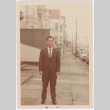 Lawrence Miwa poses on sidewalk (ddr-densho-437-6)