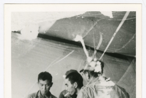 Three soldiers in a medic tent (ddr-densho-1007-298)