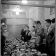 Group standing for a toast at banquet table (ddr-densho-426-2024)