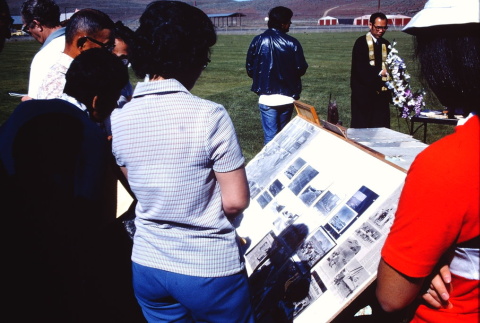 Pilgrims looking at a photograph display at the former site of Tule Lake (ddr-densho-294-31)