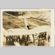 Men inspecting a plane on an aircraft carrier (ddr-njpa-13-177)
