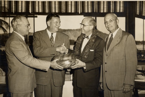 Four men exchanging a bowl (ddr-njpa-1-495)
