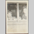 Two girls looking out from a window (ddr-densho-278-170)