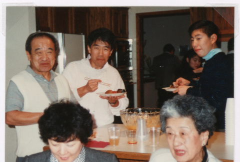 People eating in kitchen (ddr-densho-477-644)
