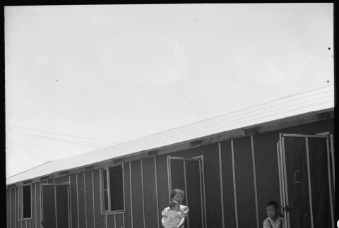 Woman and children outside barracks (ddr-densho-151-73)