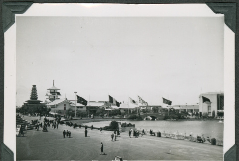 Large water feature with flags along road (ddr-densho-475-487)