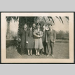 Group photo of six people beside a palm tree (ddr-densho-483-339)