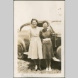 Two women standing in front of a car (ddr-densho-316-54)