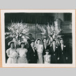 Henri Takahashi and Tomoye (Nozawa) Takahashi standing at altar with wedding party (ddr-densho-410-481)