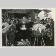 Mourner holds a portrait of Masao Kadonaga (ddr-densho-37-1389)