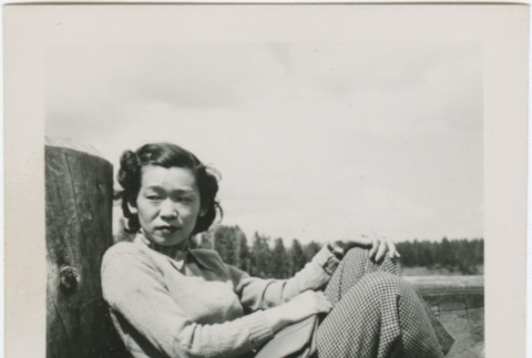 Guyo Tajiri sitting on a dock (ddr-densho-338-281)