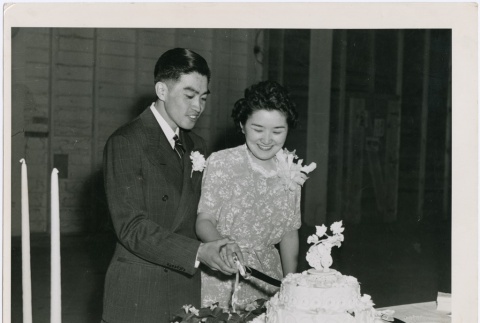 Milton and Molly Maeda cutting their wedding cake (ddr-densho-287-14)