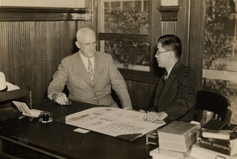 Lester Petrie and another man seated behind a desk (ddr-njpa-2-808)