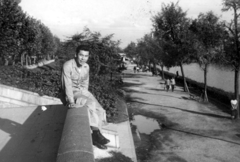 Young man sitting on roof (ddr-densho-2-56)