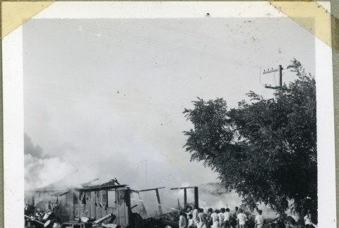 A crowd gathered near a burning barracks (ddr-manz-4-139)