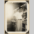 Frank Eya holding a bottle (ddr-densho-542-545)