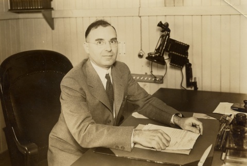 Man posing at his desk (ddr-njpa-2-924)