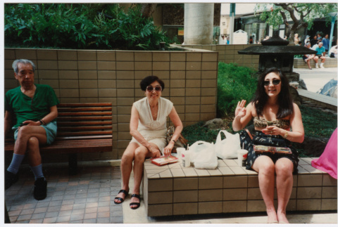 Tomi Iino and young woman eating food outside shopping center. (ddr-densho-368-316)