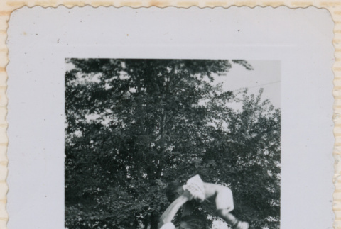 Tom holding baby above head (ddr-densho-462-174)