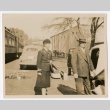 Henrietta Schoen with a man in front of ambulances and a train (ddr-densho-223-8)