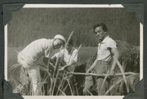 3 men sitting near harbor (ddr-densho-540-65)