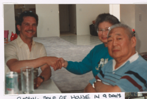 Mitzi and Takeo Isoshima with real estate agent (ddr-densho-477-669)