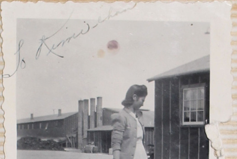Woman standing outside barracks (ddr-densho-464-45)
