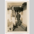 Two men standing in front of door with sign in Japanese (ddr-densho-223-15)