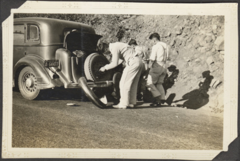 Three men changing a tire (ddr-densho-326-602)