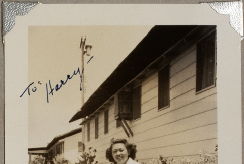 Woman sitting on lawn outside building (ddr-densho-587-65)
