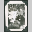 Man cooking over fire (ddr-densho-475-668)