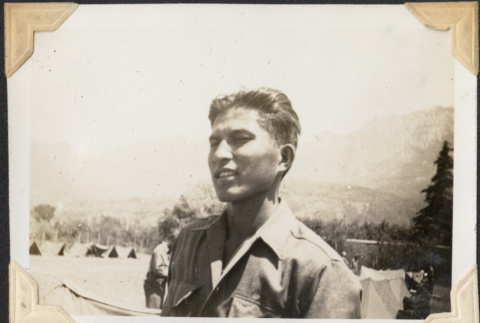 Man with hills and tents in background (ddr-densho-466-656)
