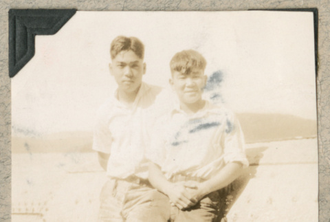 Two men standing along beach (ddr-densho-383-140)
