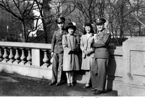 Two men in uniform standing with two women (ddr-ajah-2-810)