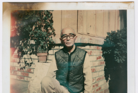 Man poses outside house (ddr-densho-501-33)
