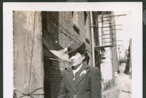 Photo of a woman wearing a hat and coat (ddr-densho-483-335)