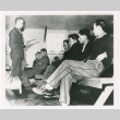 Seated figures addressed by military personnel (ddr-densho-1007-23)
