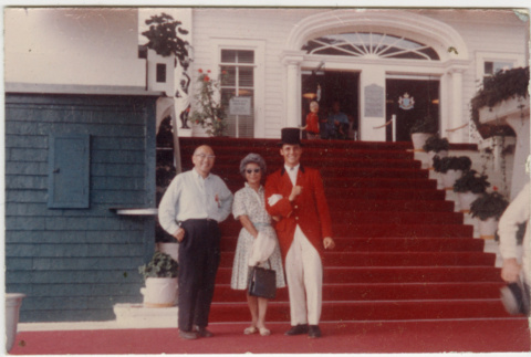 Chester and Agnes Sakura posing with man in doorman's uniform (ddr-densho-523-377)