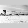 View of camp perimeter and guard tower (ddr-densho-37-237)