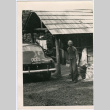 Man poses in front of cabin (ddr-densho-359-1290)