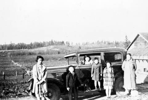 Family in front of their car (ddr-densho-76-5)