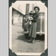 Woman holding girl next to car (ddr-densho-316-373)
