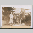 Two women and five children posing by stone pillar (ddr-densho-483-1008)