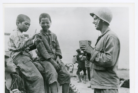 Soldier Joseph Barabas talks to Okinawan children (ddr-densho-1007-87)