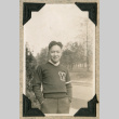 Tad Yonago wearing University of Washington sweater (ddr-densho-383-332)