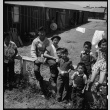 Young Japanese Americans gathering outside barracks (ddr-densho-151-253)