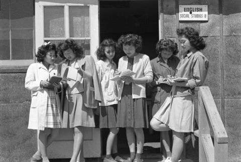 High school girls reading in front of the English and Social Studies barracks (ddr-fom-1-731)